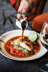 An Exquisite Gourmet Plated Fish Dish Accompanied by a Savory