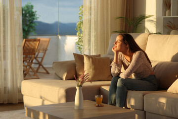 Obraz premium Relaxed woman resting with closed eyes sitting at home