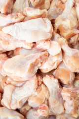 Close-up full frame view of many raw, fresh chicken wings, drumettes, and flats, ready for cooking. Food Preparation.