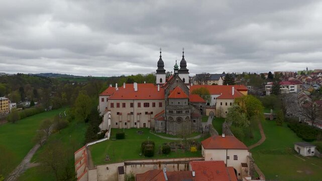 Dramatic drone orbit around the towering St. Procopius Basilica (Bazilika svateho Prokopa), a 12th-century UNESCO landmark overlooking the town of Trebic, Moravia, Czech Republic.