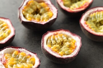 Fresh passion fruits on grey table, closeup