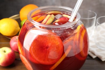 Tasty punch and fruits on wooden table, closeup. Refreshing drink