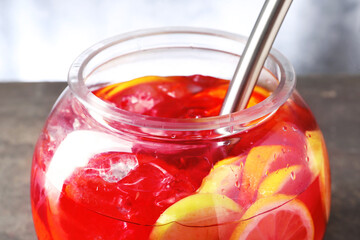 Fruity punch on grey table, closeup. Refreshing drink