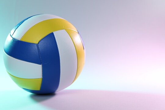 Colorful volleyball ball on light background. Space for text