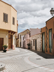 Serene alley with vibrant facades against a vivid blue sky. Picturesque urban setting with delightful blend of colors