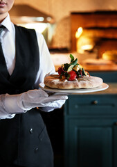 Elegant dessert presentations by waitstaff in upscale restaurants create a