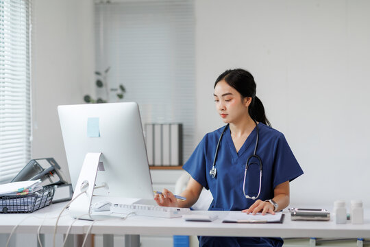 Female doctor working on computer in medical office