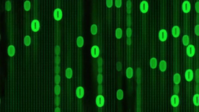 Visual display of green binary code cascading against a black background, creating an abstract digital atmosphere that evokes technology and data processing.
