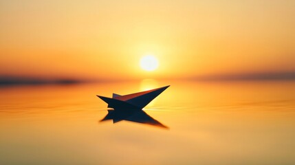A paper boat floats on calm water reflecting a vibrant sunset, creating a serene ambiance