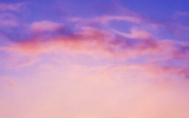 Purple golden yellow orange sky and white cumulus cloud. Sunset sunrise cloudscape sky.