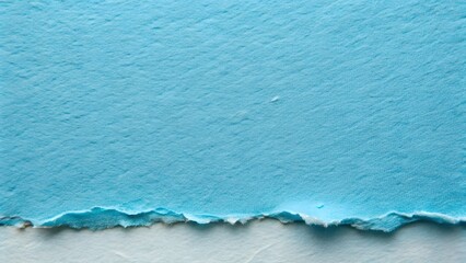 Close-up textured surface of torn light blue handmade paper with rough edges on white background