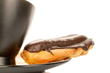 Chocolate sweet eclair, macro, isolated on white background.