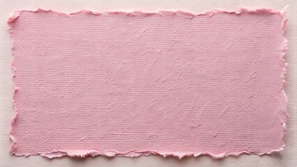 Soft pink handmade paper with textured uneven edges on light surface