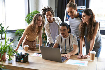 Stylish coworkers collaborating on a project in a bright and modern office space