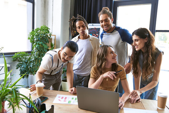 Young stylish coworkers collaborating in a vibrant office environment during a brainstorming session