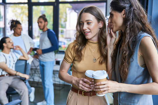 Stylish young professionals enjoy a collaborative moment in a modern coworking space