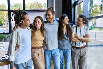 Young stylish coworkers enjoy a lighthearted moment in a vibrant office environment
