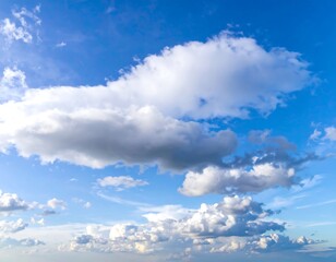 Obraz premium Fluffy white clouds against a vibrant blue sky