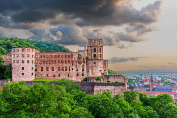 Fototapeta premium Heidelberg Castle At Dusk Surrounded By Lush Greenery And Dramatic Clouds
