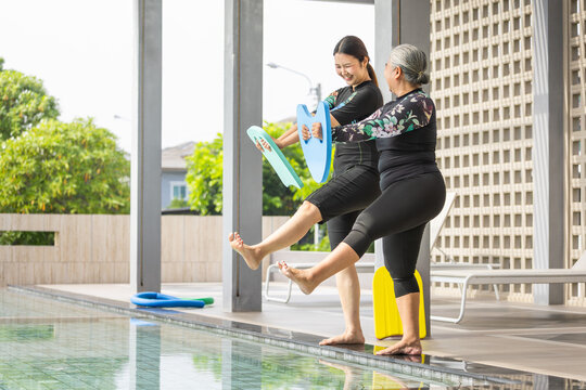 Female Trainer Teaching Senior Woman Swimming Exercise, Senior Woman and Instructor Doing Aqua Aerobics, Active Seniors Exercising by the Pool, Personal Water Fitness Training Session
