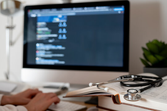 Medical student engaging with an ai-powered chatbot on a computer for e-learning and healthcare research. Surrounded by a stethoscope and medical books. Blending technology with traditional medicine