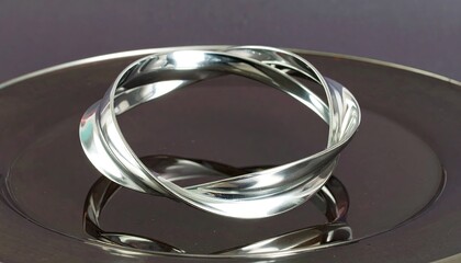 Silver Helix Bracelet on Dark Reflective Surface