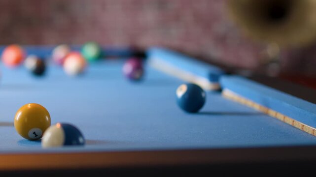 Player Lines Up Shot on Blue Pool Table in Bar