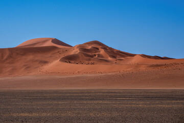 Landscape of the red sand dunes of Sossusvlei in the Namib Nauklft National Park in Namibia
