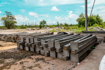 Construction site with cement factory, mixer trucks, and concrete silos