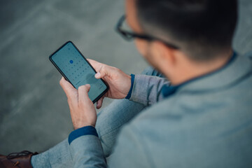 Businessman using mobile phone to check calendar app
