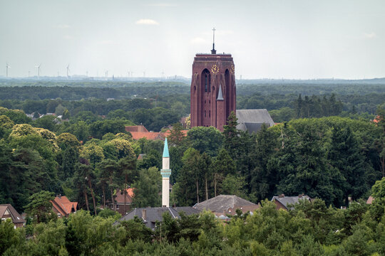 Maasmechelen Tevhid mosque and St Barbara church seen from the Long Terill in Hoge Kempen National Park, Belgium