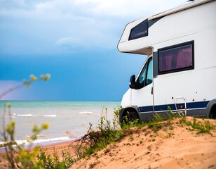 White campervan parked on sandy beach near ocean