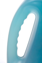A vertical, close-up studio shot of the translucent handle and side of a laundry detergent bottle, showing the ergonomic design and fluid level