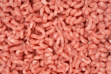 A close-up, top-down view of raw ground pork and beef, showing the texture and spiral shapes of the minced meat