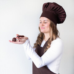 Chocolatier with handmade homemade chocolate balls in the hands