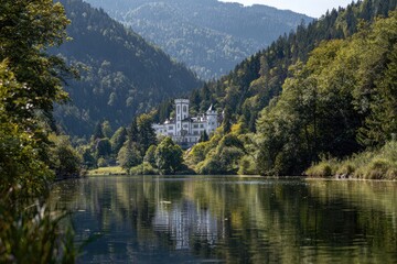 Fototapeta premium Picturesque castle reflected on a tranquil lake nestled in a valley