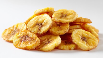 Stack of golden banana chips with darker centers evenly lit against a neutral background