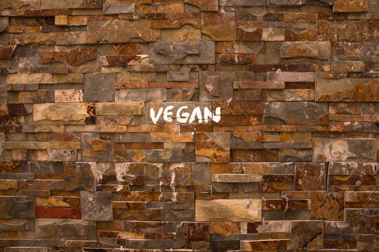 Single word written on brown brick wall