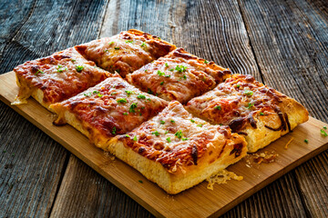Pizza al metro margherita on wooden table