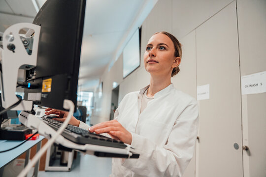 Medical professional analyzing data in laboratory clean room
