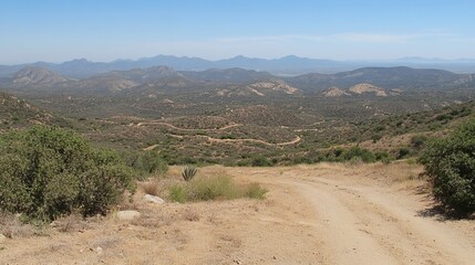 Desert mountain vista, dirt road descends