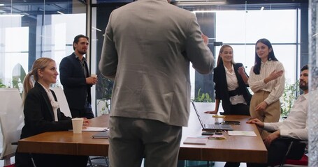 Chief leading a meeting with a team of employees and business people in the office. The group emphasizes teamwork, communication, and collaboration to achieve professional work goals. - Powered by Adobe