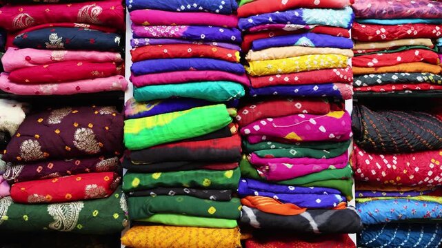 stack of indian traditional colorful saree at retail store at indoor
