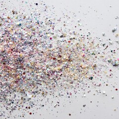 A scattered pile of iridescent glitter, various pastel and metallic colors, on a light grey background