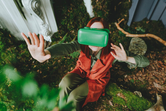 Woman wearing virtual reality simulator gesturing in abandoned place