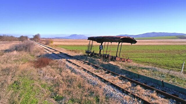 Fields in the autumn, railway track, wrecked wagon station, skyline