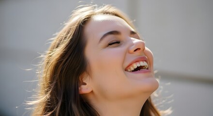 Happy Young Woman Laughing with Joy in the Bright Sunlight.