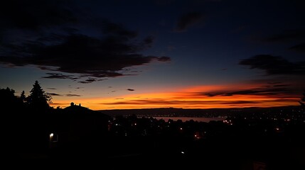 Dawn silhouettes city, fiery orange sky