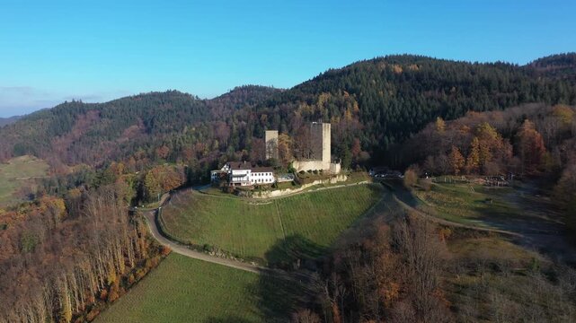Aerial view of Windeck Castle standing majestically amidst the vibrant autumnal foliage, a contrast of ancient stone and colorful trees, B&uuml;hl, Baden-W&uuml;rttemberg, Germany.