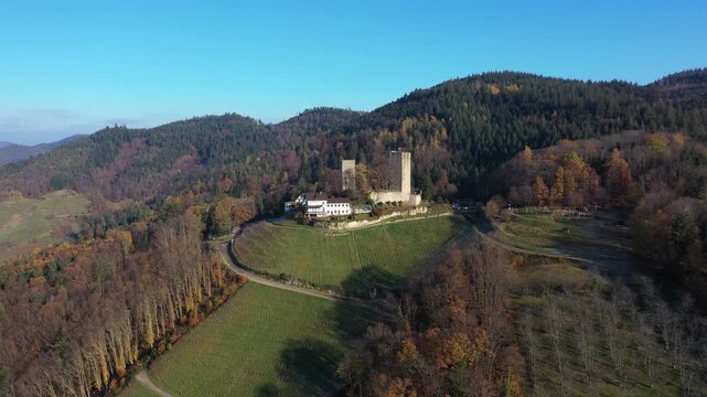 Aerial view of Windeck Castle stands majestically atop a hill, surrounded by lush forests displaying a tapestry of autumnal colors, B&uuml;hl, Baden-W&uuml;rttemberg, Germany.